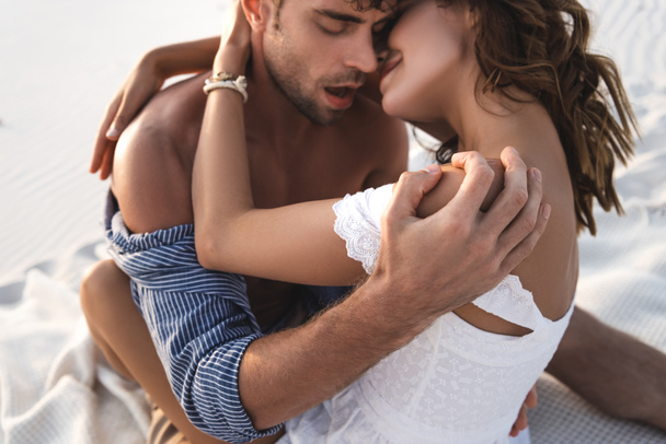 passionate young couple kissing on sandy beach - Fotoğraf, Görsel