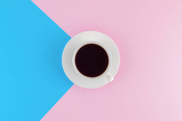 A cup of freshly brewed coffee on beautiful pink and bright blue pastel background. Fresh desserts. Meringue. Pink Chocolate. Top view. Flat lay.  - Foto, afbeelding