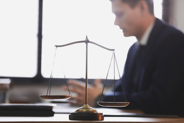 Scales of justice and blurred lawyer on background - Photo, Image