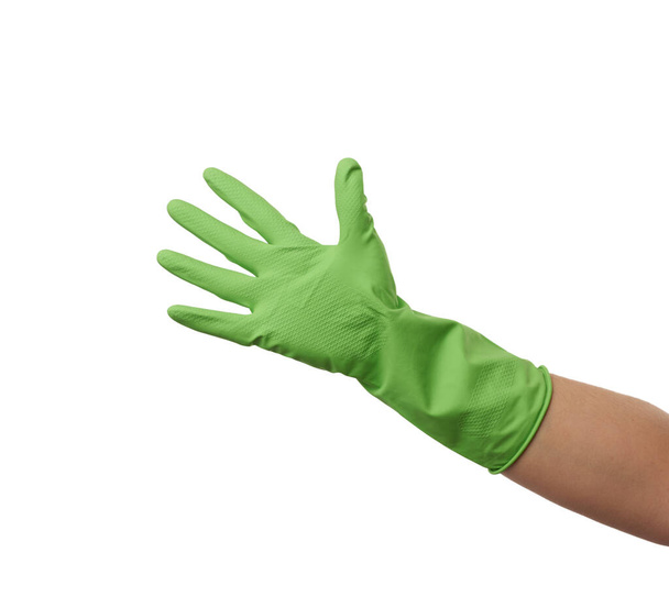 green rubber glove for cleaning is dressed on the hand, protection of the hands from chemicals, isolated white background - Photo, image