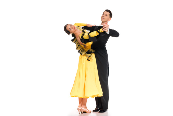 elegant young couple of ballroom dancers dancing on white - Foto, immagini