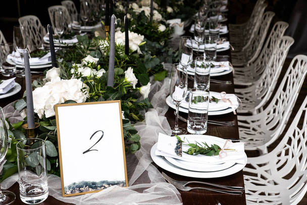 Framed table number at the festive banquet. - Foto, afbeelding