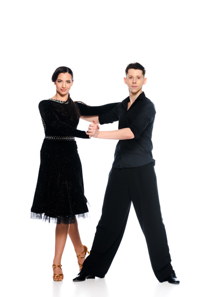 elegáns fiatal pár báli táncosok fekete ruha és öltöny tánc elszigetelt fehér - Fotó, kép