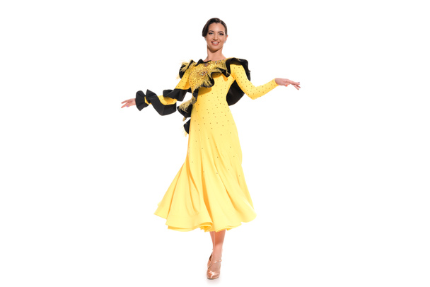 smiling elegant young ballroom dancer in yellow dress dancing isolated on white - Foto, imagen