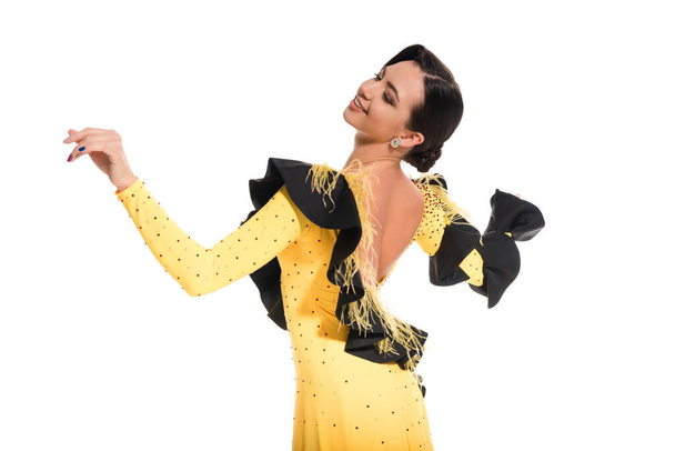 sonriente elegante joven bailarina de salón en vestido amarillo bailando aislado en blanco
 - Foto, imagen