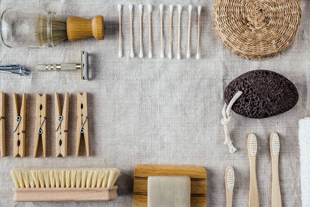 Natural wooden plastic free washing utencils on natural linen fabric background. Sustainable simple living background border frame. Empty space, room for text.  - Foto, Imagen