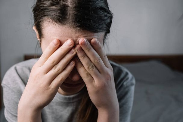 Close up images of thoughtful insecure young woman touching forehead having headache migraine or depression, stressed frustrated anxious lady doubting deciding troubled with grief sorrow concept. - Foto, Bild