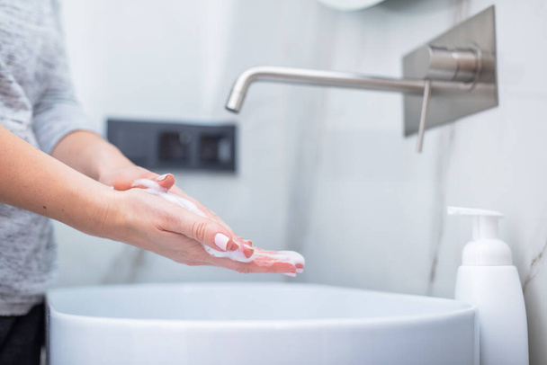Woman washing hands with foam soap. Hygiene, preventing coronavirus and healthcare - Photo, Image