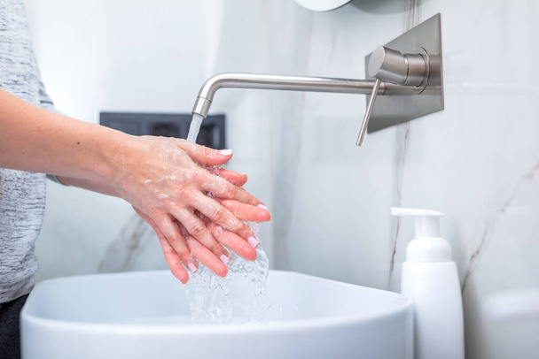 Kobieta myje ręce piankowym mydłem. Higiena, zapobieganie koronawirusowi i opiece zdrowotnej - Zdjęcie, obraz