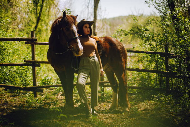 Beautiful woman with brown horse - Фото, зображення