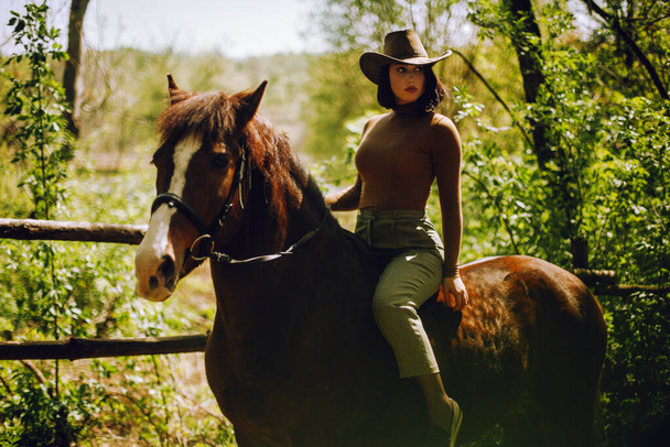 Beautiful woman with brown horse - Фото, зображення