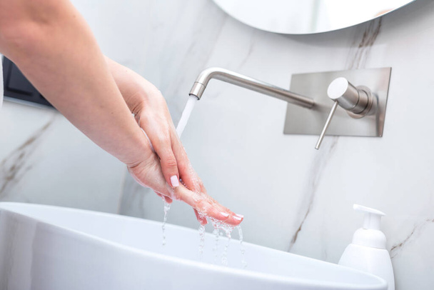 Woman washing hands with foam soap. Hygiene, preventing coronavirus and healthcare - 写真・画像