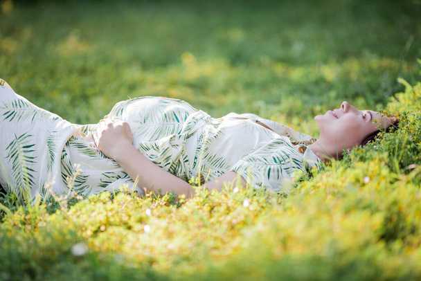 Portrait of a beautiful young pregnant woman in eco dress. Motherhood. A family. Summer. - Foto, Imagem