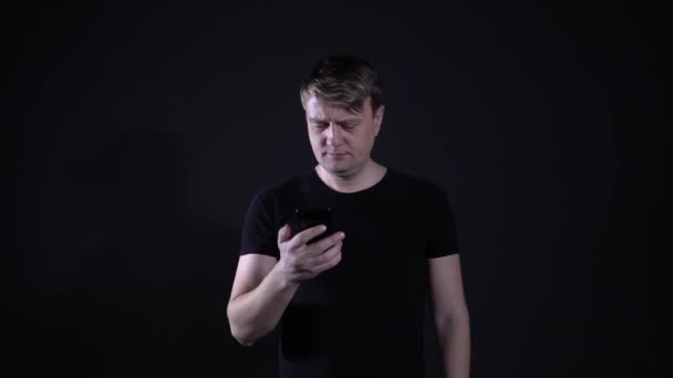 The man on the phone Hello on a black background - Felvétel, videó