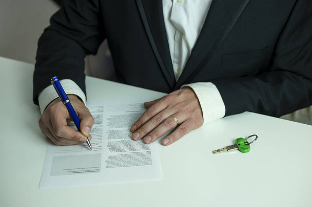 hands of a man in a suit signing a mortgage loan, financial concept - Photo, Image