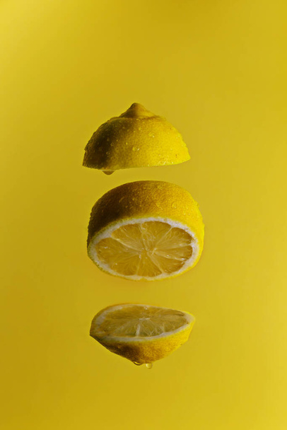 yellow lemon sliced on a yellow background - Photo, Image