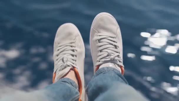 male legs in sneakers hanging from the yacht - Footage, Video