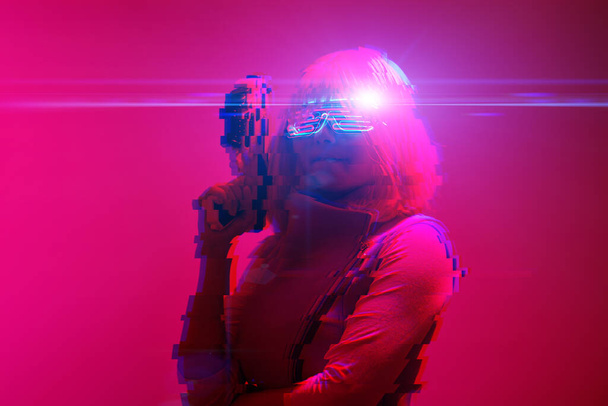 Girl with blaster in the futuristic battle. Concept virtual reality, cyber game. Image with glitch effect. - Foto, Imagem