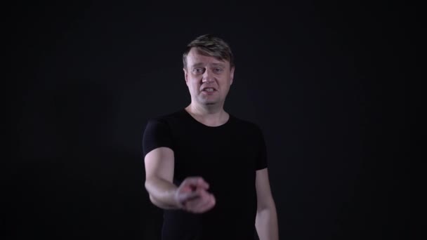 guy calls a finger on you to Seeb on black background - Filmagem, Vídeo