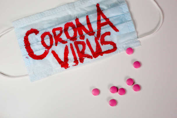 Surgical face mask with coronavirus text written on it.  - Foto, Imagem