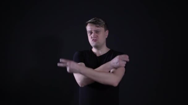 The guy shows a sign of peace on black background - Záběry, video