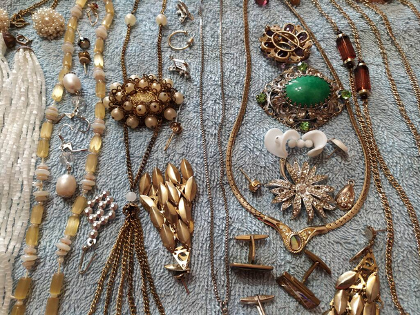 Old vintage jewelry close-up. Beads, chains, brooches. Background, wallpaper. - Photo, Image