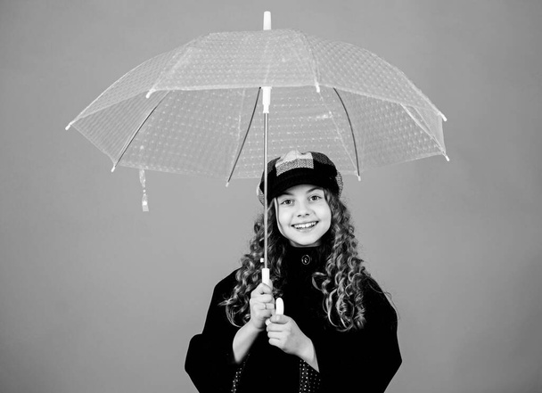 Fall season. Kids fashion trend. Love rainy days. Kid girl happy hold transparent umbrella. Enjoy rainy weather with proper garments. Waterproof accessories make rainy day fun. Enjoy rain concept - Valokuva, kuva
