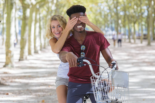 happy young couple having fun riding a bicycle - Fotoğraf, Görsel