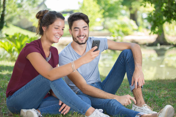 young couple doing selfie outdoors - Fotó, kép
