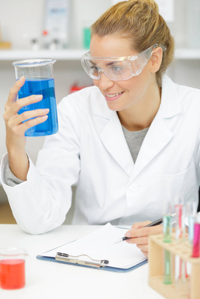 female scientist with laboratory glass - Фото, изображение