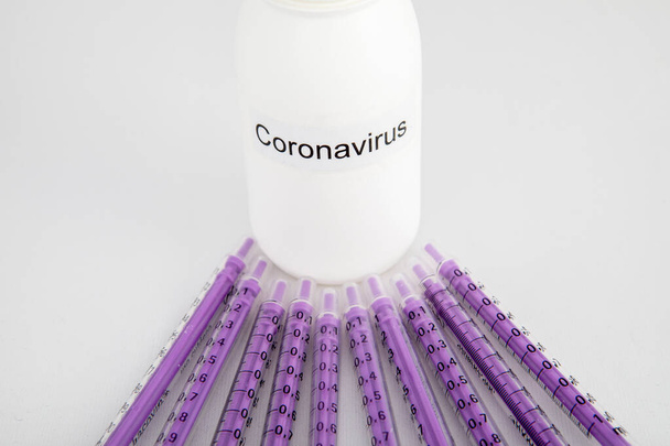 white bottle of coronavirus with syringes on white background - Photo, Image
