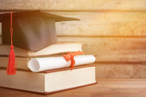 Graduation hat and books - Фото, изображение