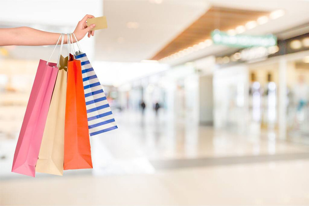 Young woman with shopping bags and credit card  - Photo, image