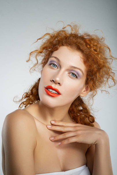 Attractive curly haired girl posing on camera - Photo, image