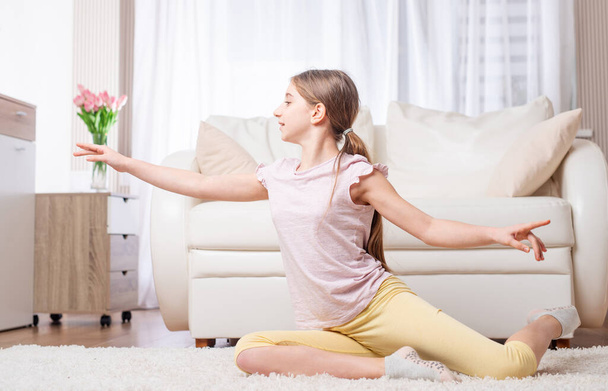 Teen doing exercises indoors - Фото, изображение