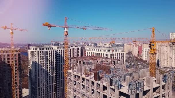 View of the construction site, top floor against the backdrop of the city and working builders - Footage, Video