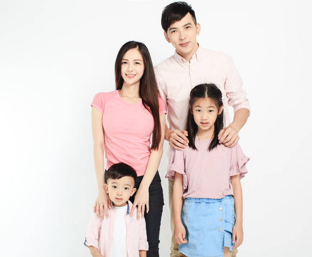 happy young asian family standing before white background - Photo, Image