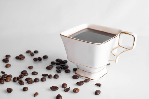 Coffee cup and beans on a white background. - Photo, Image