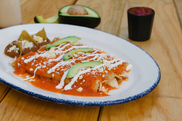 red enchiladas mexican food with tomato sauce and cheese in mexico - Photo, Image