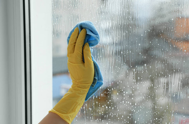 Woman cleaning window at home, closeup view - Photo, image