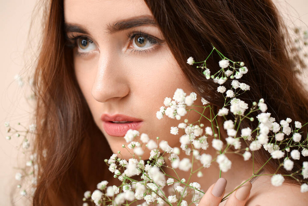 Portrait of beautiful young woman with long hair and flowers - Photo, Image