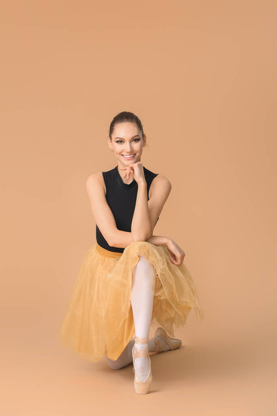 Beautiful young ballerina on color background - Фото, изображение