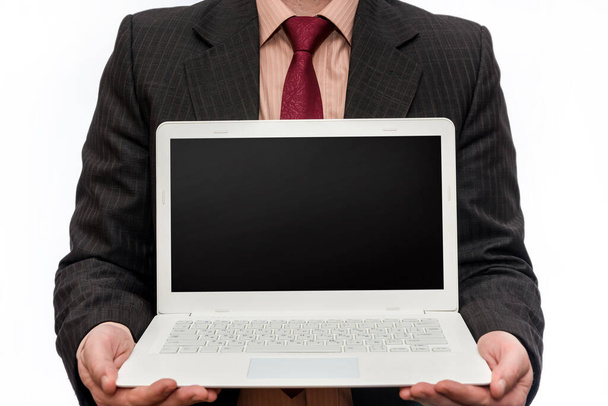 Man in suit holding laptop on white background - Foto, imagen