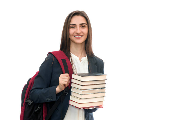 Chica joven con libros y bolsa aislada en blanco
 - Foto, Imagen