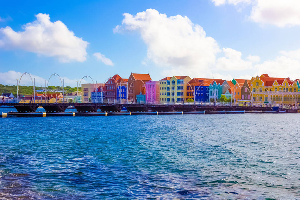 People at Queen Emma Bridge in front of Punda district, is a pontoon bridge St. Anna Bay at Willemstad, Curacao, Netherlands - Photo, Image