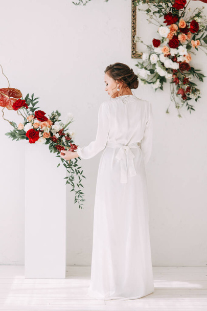  Decor of the ceremony with red roses. Portrait of the bride in the style of fine art. Wedding lace dress on the girl. - Photo, image
