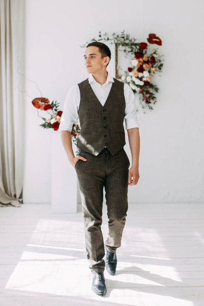 Preparing for the wedding ceremony. The preparations of the groom in the style of fine art. Portrait of the groom in the interior Studio.  - Foto, Imagen
