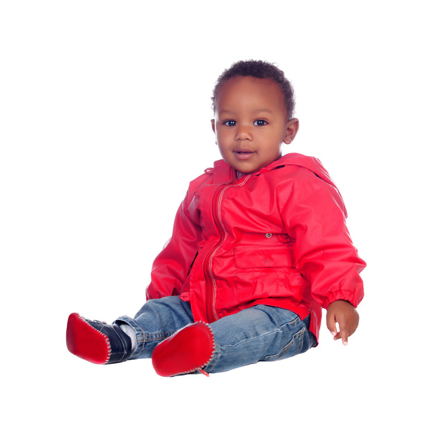 Adorable african baby sitting on the floor with red raincoat - Fotoğraf, Görsel