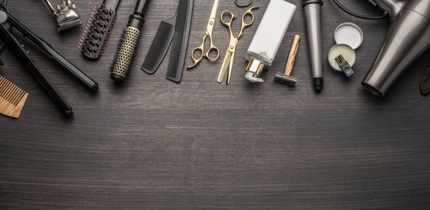 Classic grooming and hairdressing tools on wooden background. Top view on barbershop instruments  laying on dark wooden table. - Fotó, kép