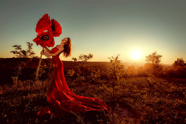 Beautiful portrait of a woman with big paper flowers - Photo, Image